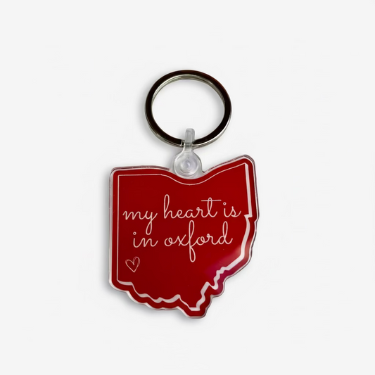 Red keychain shaped like the state of Ohio with 'my heart is in oxford' text