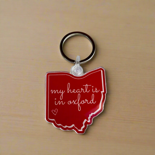 Red keychain shaped like the state of Ohio with 'my heart is in oxford' text